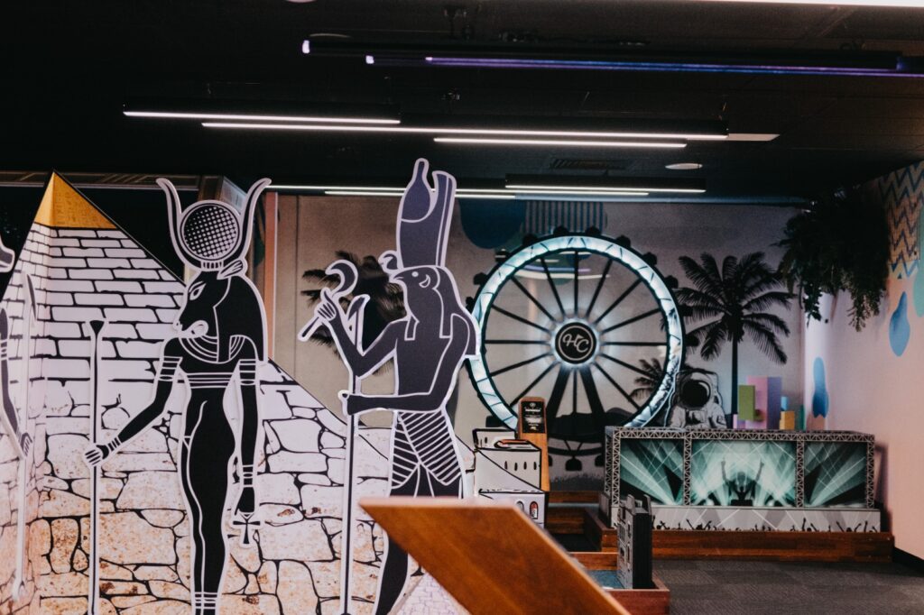 Egypt themed mini golf hole with pyramid graphics and neon lighting at Hey Caddy