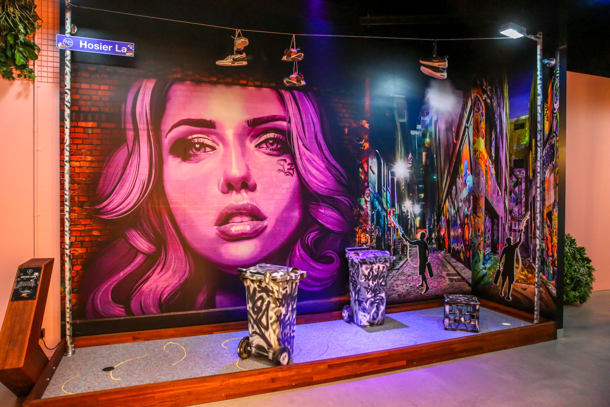 Colourful graffiti mural with woman’s face in urban alley at Hey Caddy venue