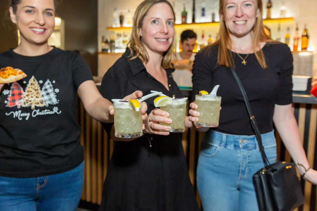 Women Drinking Cocktails at Hey Caddy Venue