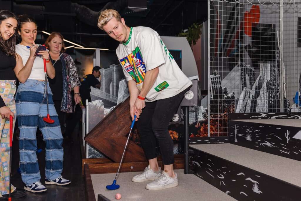 Customers playing mini golf at Hey Caddy venue