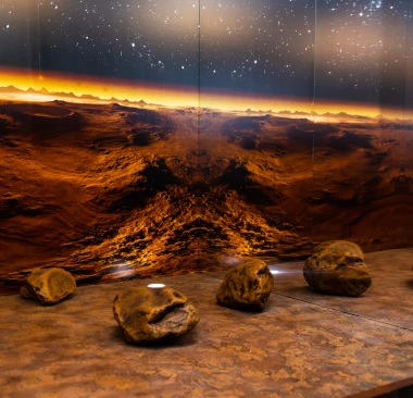 Hey Caddy mini golf course hole featuring a Mars space theme with rocky terrain obstacles and a starry horizon backdrop