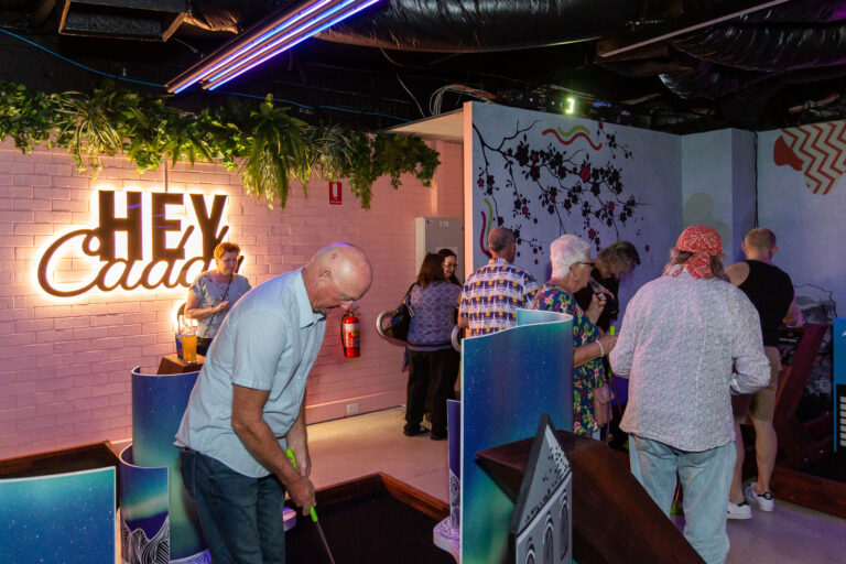 Guests enjoying indoor mini golf at Hey Caddy Balcatta