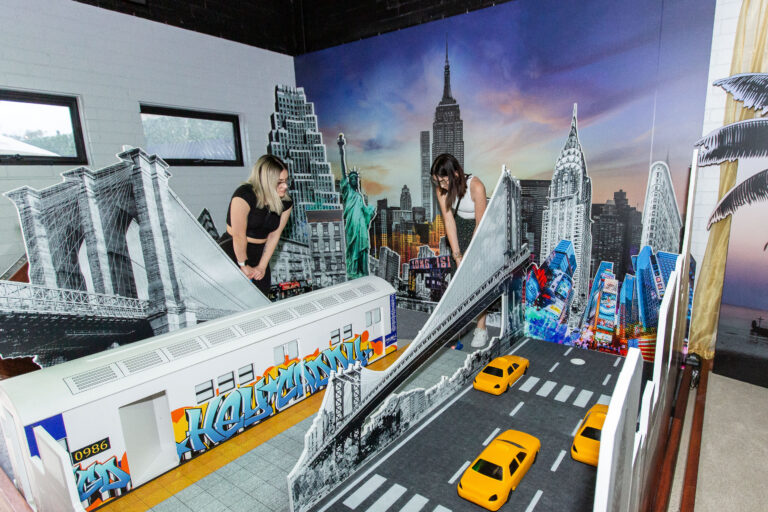 Two players on a New York-themed indoor mini golf course in Balcatta
