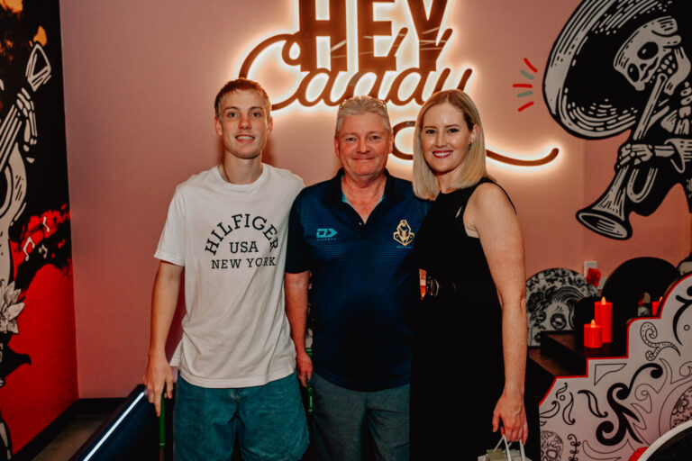 Group posing together inside Hey Caddy South Bank indoor mini golf venue