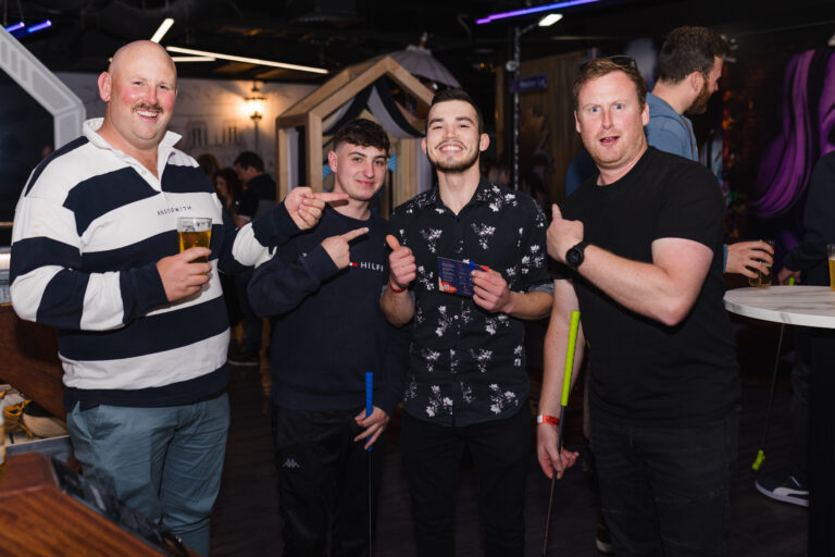 Guests playing mini golf together at Hey Caddy Marion entertainment venue