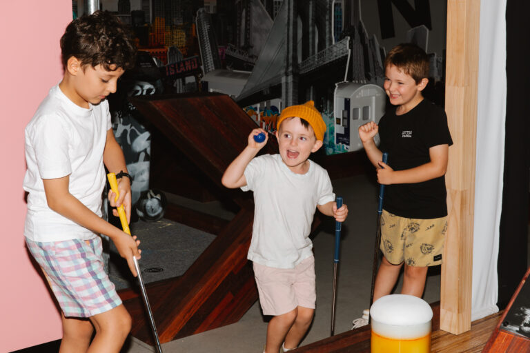 Kids enjoying indoor mini golf together at Hey Caddy South Bank