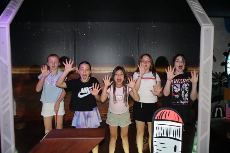 Kids having fun on the indoor mini golf course at Hey Caddy Macarthur