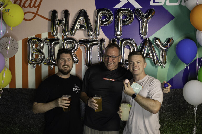 Friends celebrating a birthday with drinks at Hey Caddy Rockingham