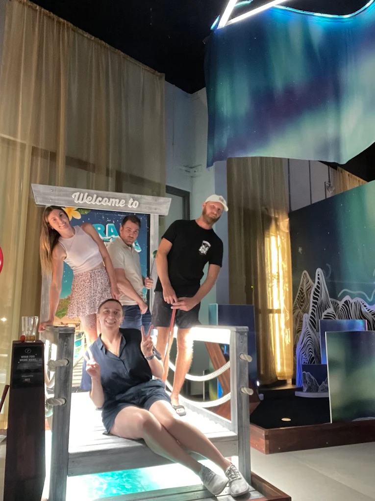 Group enjoying a themed indoor mini golf course together at Hey Caddy North Lakes