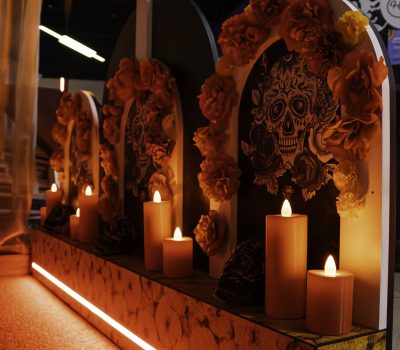 Day of the Dead themed mini golf hole with candles and skull decorations at Hey Caddy