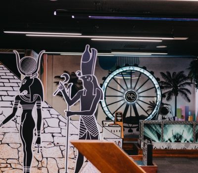 Egypt themed mini golf hole with pyramid graphics and neon lighting at Hey Caddy