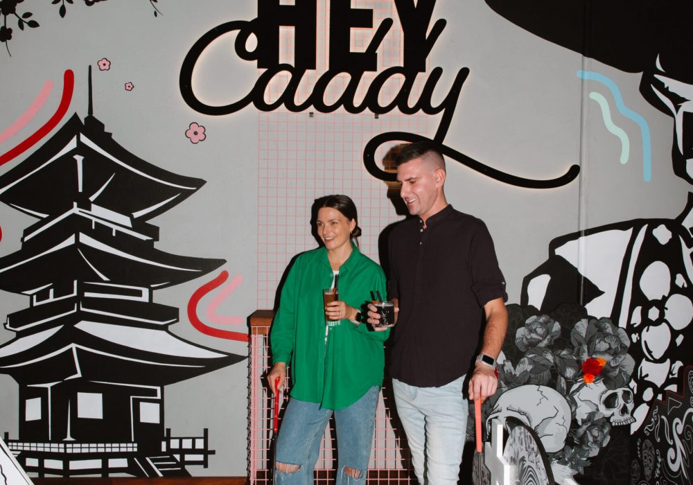 Couple playing mini golf at Hey Caddy venue